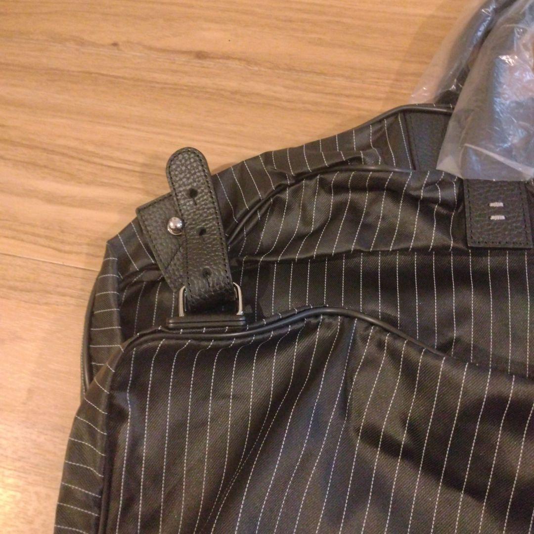 ZEGNA ストライプデザインの黒色ガーメントケース、レザー製ハンドル付き。