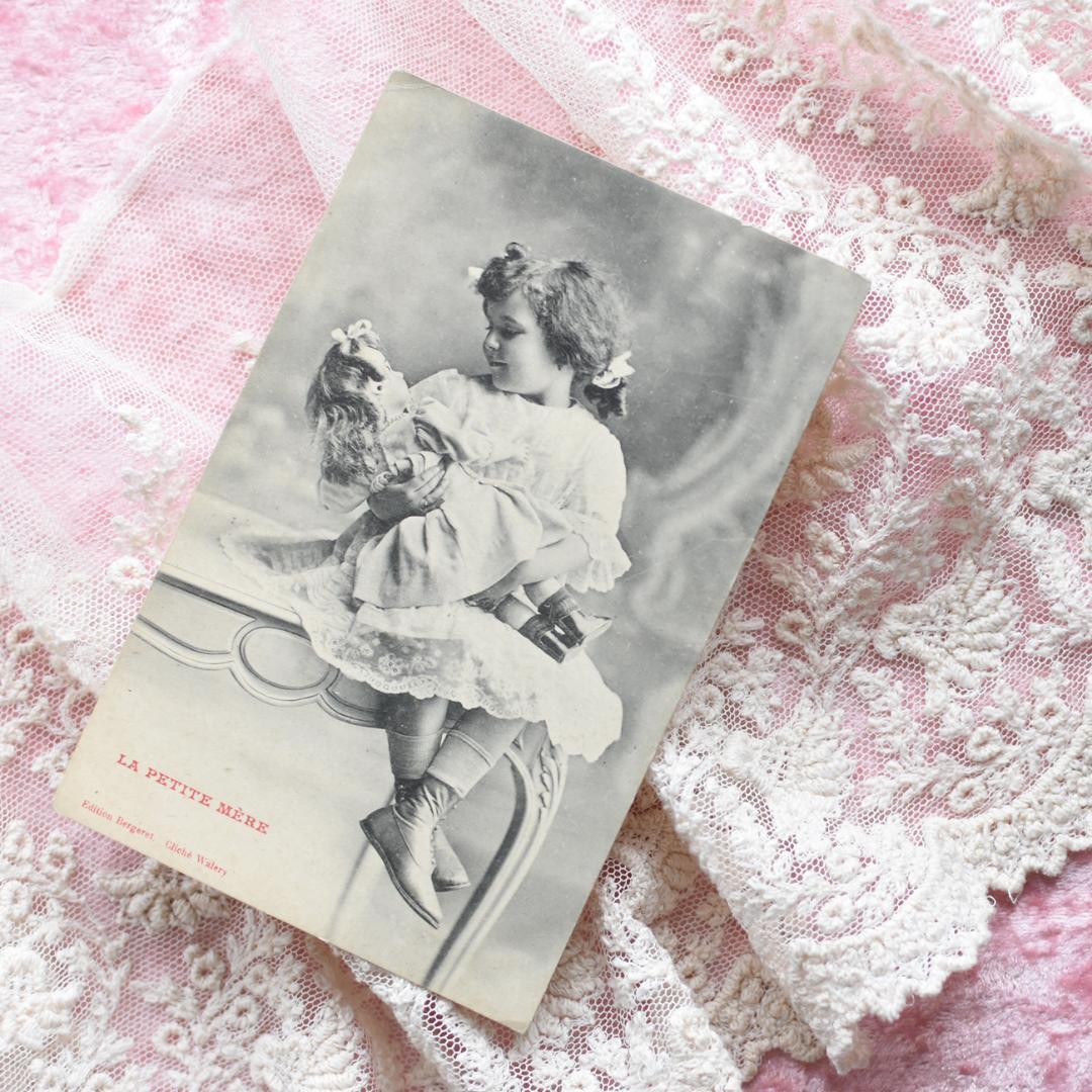 *アンティークポストカード　大きなお人形を抱く愛らしい少女