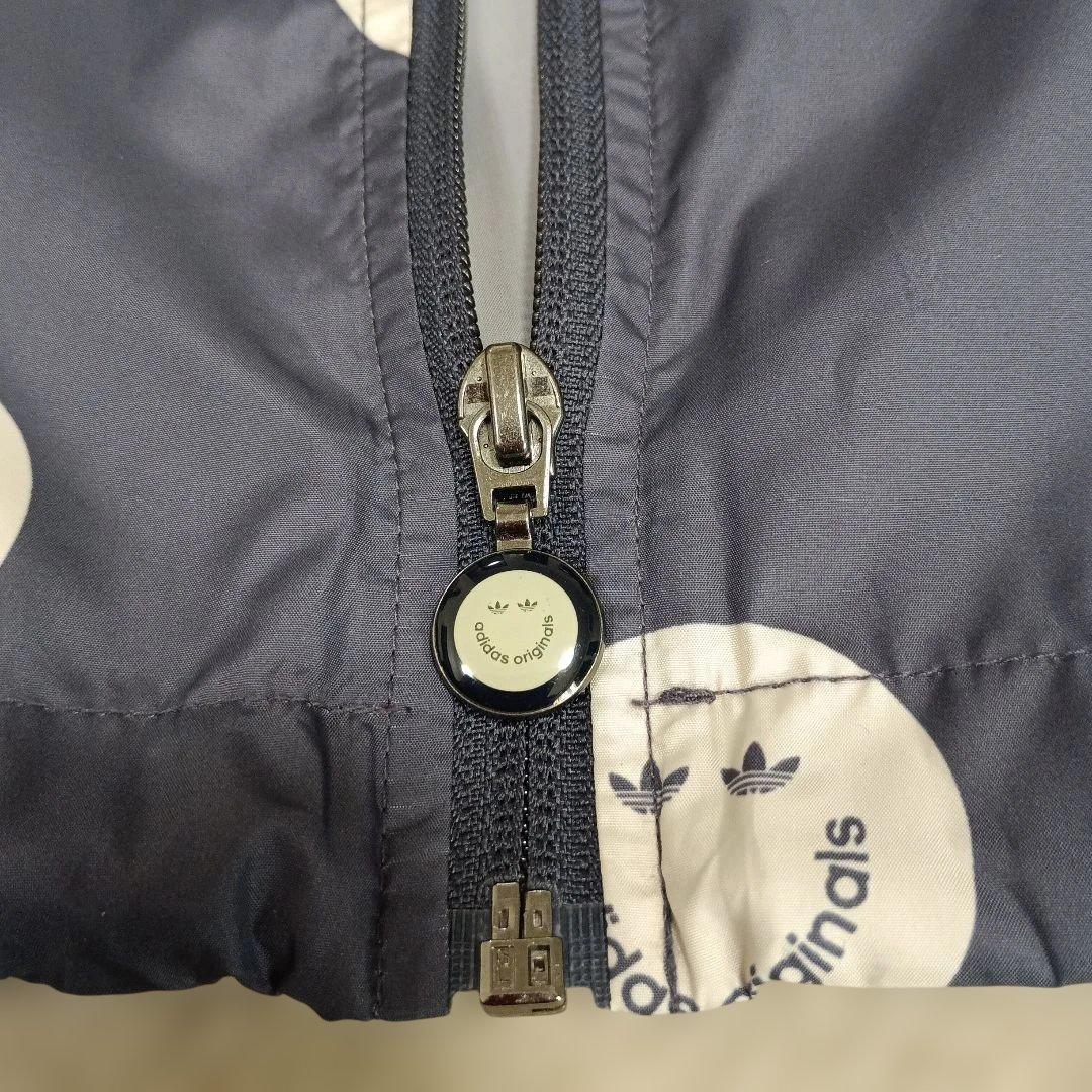 アディダスadidasプリントウィンドブレーカースマイリーフェイス